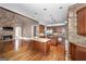 Spacious kitchen features stone accents, hardwood floors, granite counters, dual islands, and stainless appliances at 297 Collegiate Dr, Powder Springs, GA 30127