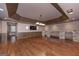 Open concept living room featuring a stone bar, hardwood floors and neutral paint, perfect for entertaining at 297 Collegiate Dr, Powder Springs, GA 30127