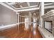 Expansive living area with stone fireplace, hardwood floors, and coffered ceilings at 297 Collegiate Dr, Powder Springs, GA 30127