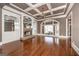 Stylish living room with coffered ceiling, built-in shelving, and stone fireplace at 297 Collegiate Dr, Powder Springs, GA 30127