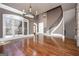 Bright living room featuring hardwood floors, stone pillar, and staircase at 297 Collegiate Dr, Powder Springs, GA 30127