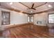 Spacious living room features hardwood floors, stone fireplace, and tray ceiling at 297 Collegiate Dr, Powder Springs, GA 30127