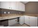 Convenient mud room with ample cabinet storage, stylish countertops, and easy access for organization at 297 Collegiate Dr, Powder Springs, GA 30127
