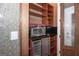 Pantry features shelving, wine fridge, microwave, and frosted glass door at 297 Collegiate Dr, Powder Springs, GA 30127