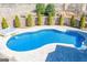 Beautiful in-ground pool with a spa, stone accents, and a private backyard setting for outdoor enjoyment at 297 Collegiate Dr, Powder Springs, GA 30127