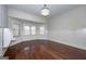 Bright room with wood floors, wainscoting, desk nook, and multiple windows with blinds at 297 Collegiate Dr, Powder Springs, GA 30127