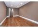 Neutral-toned room with wood-look floors, white trim, recessed lighting, and access door at 297 Collegiate Dr, Powder Springs, GA 30127
