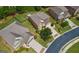 Aerial view of the house with a brick facade, manicured lawn, and a driveway leading to a garage at 3015 Arbor Song Ct, Cumming, GA 30041