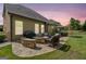Inviting backyard featuring an outdoor dining and lounge area with a stone fire pit, perfect for entertaining at 3015 Arbor Song Ct, Cumming, GA 30041