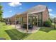 This backyard features an outdoor seating area with a pergola and a lush lawn at 3015 Arbor Song Ct, Cumming, GA 30041