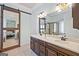 Bright bathroom features double sinks, tile floor, a decorative sliding mirror, and updated fixtures at 3015 Arbor Song Ct, Cumming, GA 30041
