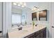 Bright bathroom features double sinks, tile floor, and updated fixtures at 3015 Arbor Song Ct, Cumming, GA 30041