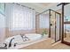 Bright bathroom showcases a soaking tub, tiled shower, and stylish fixtures at 3015 Arbor Song Ct, Cumming, GA 30041