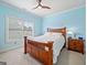 Light and airy bedroom with light blue walls and a large window for natural light at 3015 Arbor Song Ct, Cumming, GA 30041