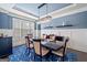 Elegant dining room with modern chandelier, wainscoting, and hardwood floors, creating a refined ambiance at 3015 Arbor Song Ct, Cumming, GA 30041