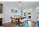 Dining room with wood table and seating, natural light and backyard access at 3015 Arbor Song Ct, Cumming, GA 30041