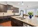 Granite countertops, stainless steel appliances, and a spacious island highlight this modern kitchen at 3015 Arbor Song Ct, Cumming, GA 30041