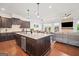 Bright eat-in kitchen featuring a center island and open layout to the living room and outside patio at 3015 Arbor Song Ct, Cumming, GA 30041