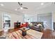 This living room features hardwood floors, a ceiling fan, and plenty of space at 3015 Arbor Song Ct, Cumming, GA 30041