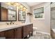 Bathroom boasts a double vanity with stone countertops, modern fixtures, and tiled floors at 2067 Skyhawk Ln, Acworth, GA 30102