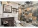Bathroom with a stone shower, dark wood vanity, and modern fixtures at 2067 Skyhawk Ln, Acworth, GA 30102