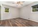Bedroom with wood floors, two windows, and a ceiling fan at 2067 Skyhawk Ln, Acworth, GA 30102