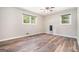 Bedroom with wood-look flooring, neutral walls, and two windows providing natural light at 2067 Skyhawk Ln, Acworth, GA 30102