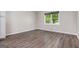 Bright bedroom with wood floors and a large window overlooking the yard at 2067 Skyhawk Ln, Acworth, GA 30102