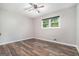 Bright bedroom featuring a ceiling fan, wood-look floors, and a window with views of the greenery at 2067 Skyhawk Ln, Acworth, GA 30102