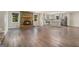 Open-concept living room with a fireplace and kitchen area with stainless steel appliances at 2067 Skyhawk Ln, Acworth, GA 30102