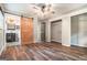 Main bedroom featuring wood floors, a barn door to the bathroom, and closet space at 2067 Skyhawk Ln, Acworth, GA 30102