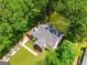 Aerial view of charming home with a fenced backyard, mature trees and inviting porch at 345 Adelle Se St, Atlanta, GA 30315