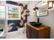 Bathroom featuring a black vanity sink, leafy wallpaper, a window, and modern lighting fixtures at 345 Adelle Se St, Atlanta, GA 30315