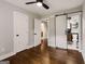 Bedroom featuring hardwood floors, white walls, standard closet, and bathroom access via sliding barn door at 345 Adelle Se St, Atlanta, GA 30315