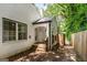 Charming brick home featuring an arched covered porch, wooden steps, and mature trees at 345 Adelle Se St, Atlanta, GA 30315