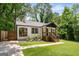 Charming renovated bungalow with white painted brick, dark trim, a new roof, a lovely front porch, and lush landscaping at 345 Adelle Se St, Atlanta, GA 30315