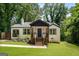 Inviting exterior featuring a well-maintained lawn, freshly painted brick, and inviting front porch at 345 Adelle Se St, Atlanta, GA 30315