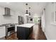 Open concept kitchen with stainless steel appliances, island with white countertop, and hardwood floors at 345 Adelle Se St, Atlanta, GA 30315