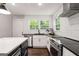 Bright kitchen featuring a stainless steel oven, dishwasher, black countertops, and white subway tile backsplash at 345 Adelle Se St, Atlanta, GA 30315