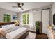 Main bedroom with hardwood floors, ceiling fan, windows with white curtains and a barn door to the closet at 345 Adelle Se St, Atlanta, GA 30315