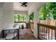 Covered patio featuring brick flooring, painted brick, and black metal railings at 345 Adelle Se St, Atlanta, GA 30315