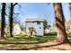 Back of home view showing a deck, white siding, well maintained lawn, and large trees at 870 Gaston Sw St, Atlanta, GA 30310