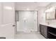 Stylish bathroom featuring a glass shower, white tiles, and a gray vanity with countertop and open shelves at 870 Gaston Sw St, Atlanta, GA 30310