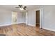 Well-lit bedroom with hardwood floors, neutral paint, ceiling fan, closet, and an en suite bathroom at 870 Gaston Sw St, Atlanta, GA 30310