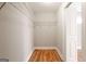 Walk-in closet with hardwood floors and built in shelving at 870 Gaston Sw St, Atlanta, GA 30310