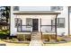 The front entry features a cozy porch, stylish railings, and a freshly landscaped garden at 870 Gaston Sw St, Atlanta, GA 30310