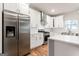 This kitchen boasts stainless steel appliances, a center island, and white cabinets at 870 Gaston Sw St, Atlanta, GA 30310