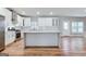 Bright kitchen features an island, white cabinets, and stainless steel appliances at 870 Gaston Sw St, Atlanta, GA 30310