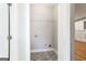 A compact laundry area boasts patterned tile flooring and convenient built in shelving, next to the kitchen at 870 Gaston Sw St, Atlanta, GA 30310