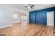 Open-concept living room boasts hardwood floors and a blue accent wall at 870 Gaston Sw St, Atlanta, GA 30310